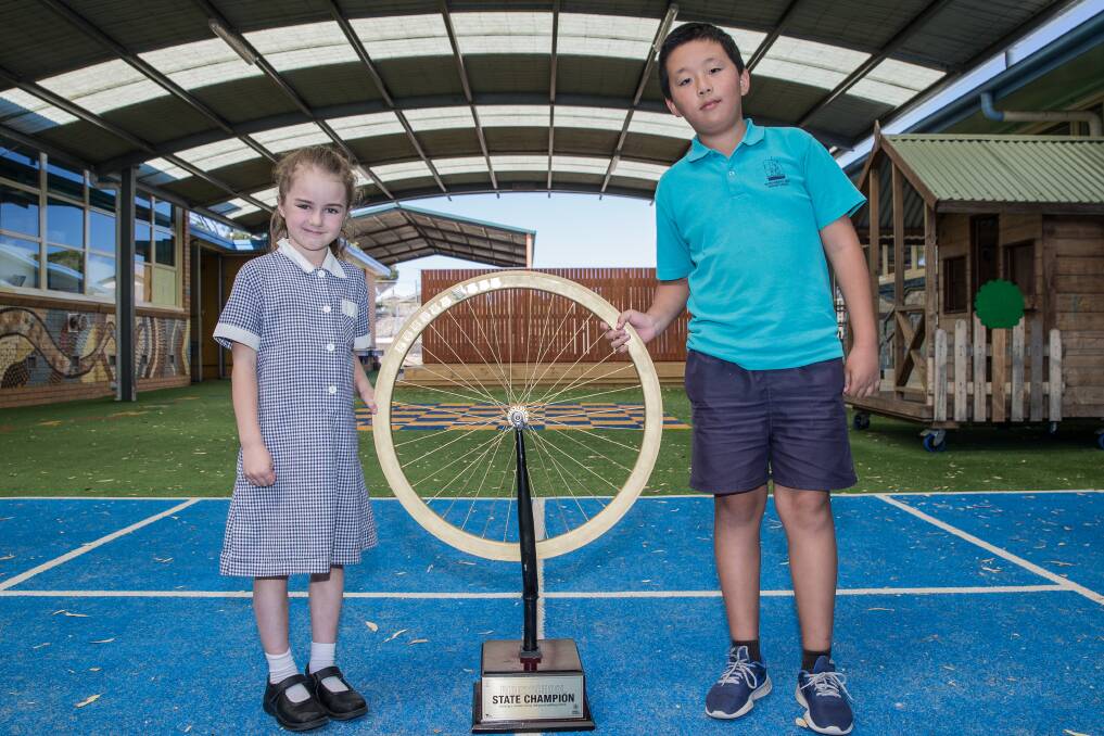 Wheelie good: Warrnambool West Primary School students Zoey Clays, 7, and Xi Chen, 12, are excited their school won the Golden Wheel award. Picture: Christine Ansorge