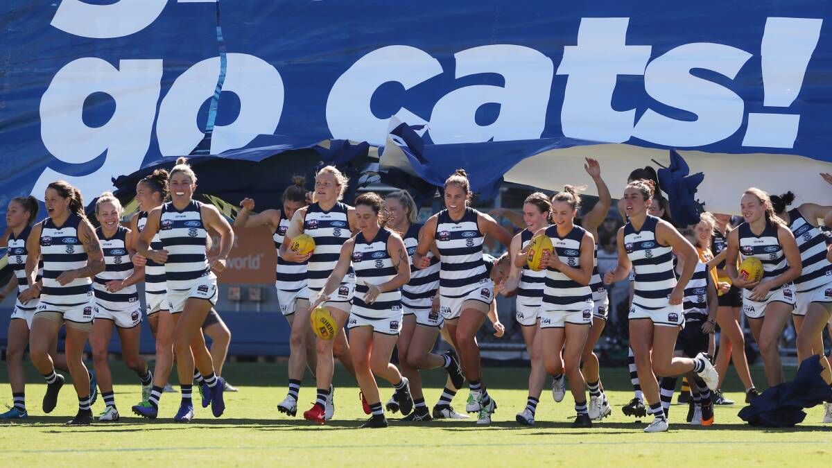 Georgia Clarke running out onto GMHBA Stadium with her teammates in her first AFLW home game for Geelong. Picture: AAP/David Crosling.