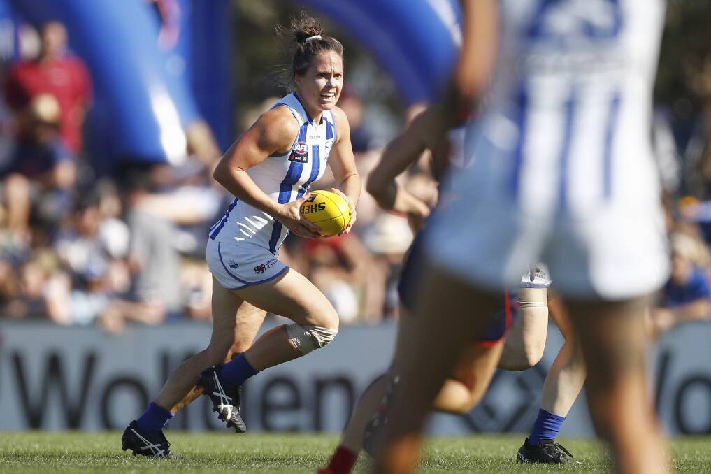 Captain fantastic: Emma Kearney runs with the ball during the round fouir AFLW match between Melbourne and North Melbourne. Picture: AAP/Daniel Pockett