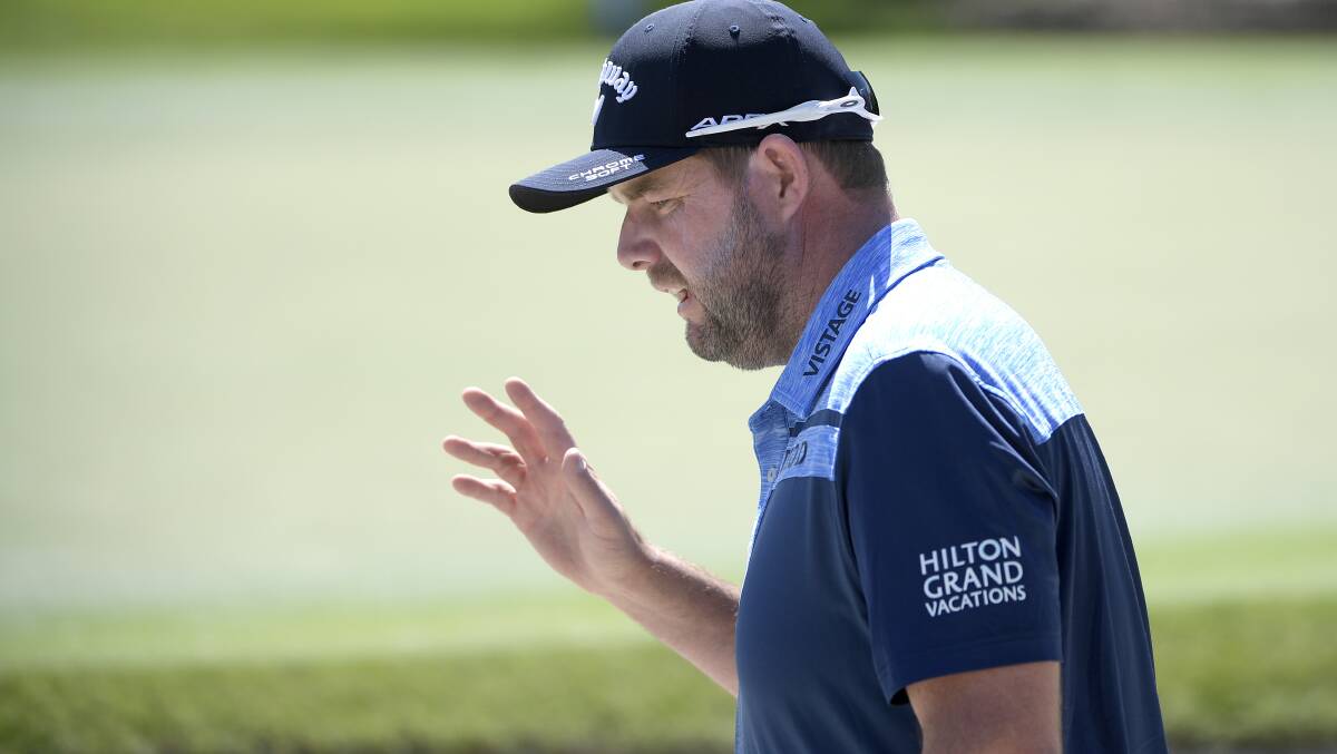 Warrnambool's Marc Leishman acknowledges the crowd after hitting from a bunker onto the first green during the first round of the Arnold Palmer Invitational golf tournament. He could be one of only four Australians in the Masters.