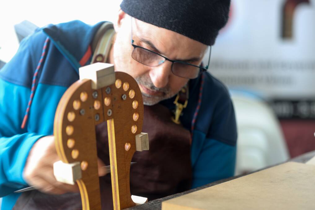 Precision: Violin maker Sandro Giomi keeps his hands busy during the Folkie. Pictures: Rob Gunstone