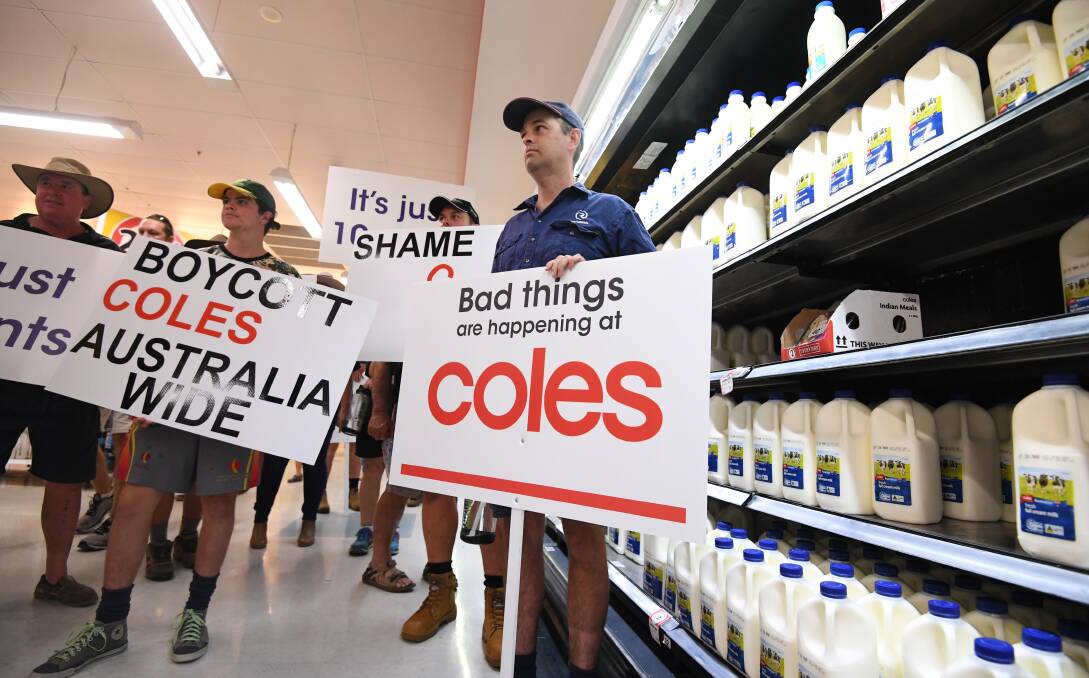 Pressure: Queensland dairy farmers protest inside a Coles supermarket store in Brisbane last week.