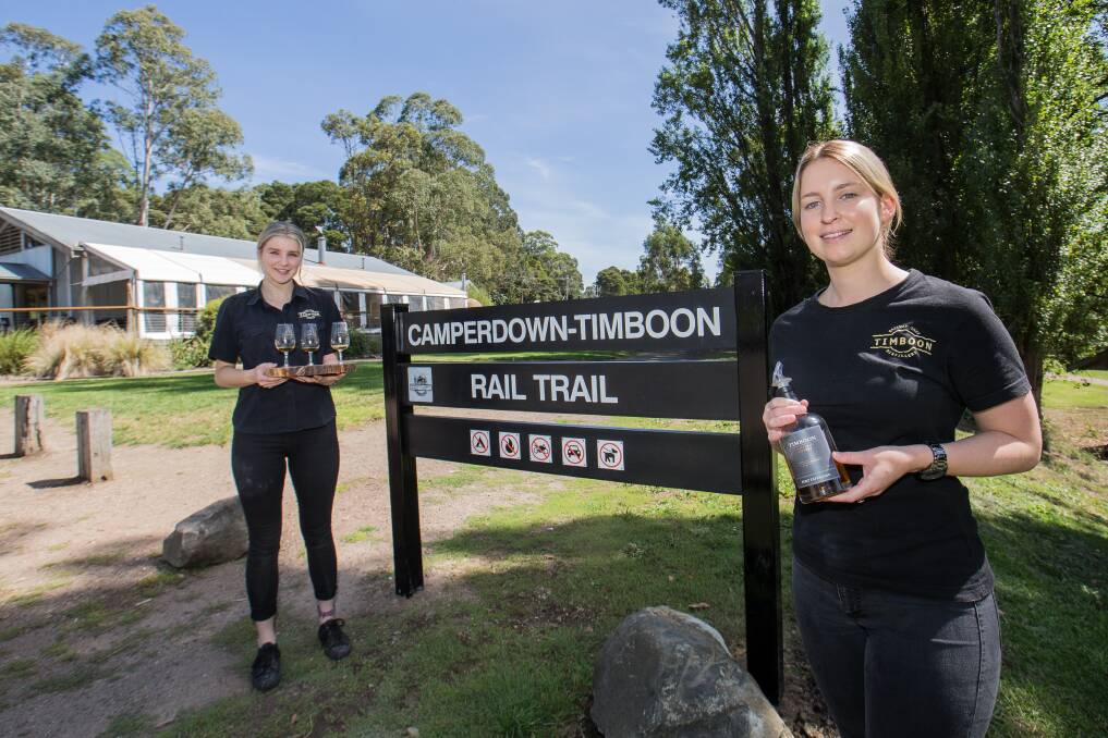 CHEERS: Timboon Railway Shed Distillery staff Sarah Walker and Laura Rosolin look forward to welcoming more people to the town. Picture: Christine Ansorge