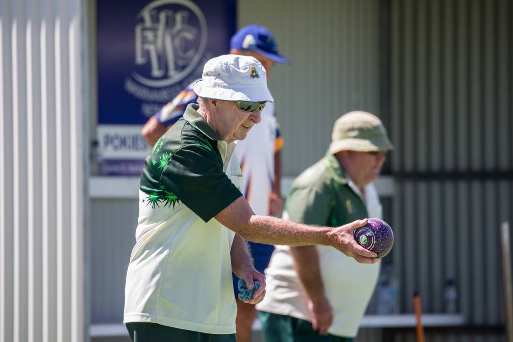 LINE IT UP: City Memorial Red bowler Ray Hoy prepares his shot against Warrnambool Gold in Saturday's Western District Bowls Division preliminary final. Picture: Christine Ansorge