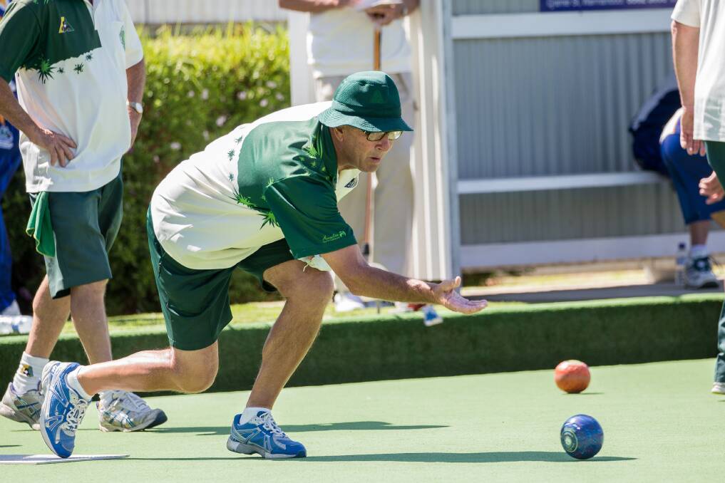 ON TARGET: City Memorial Red's Paul Symmons rolls his shot down the green against Warrnambool Gold in Saturday's Western District Bowls Division preliminary final. Picture: Christine Ansorge