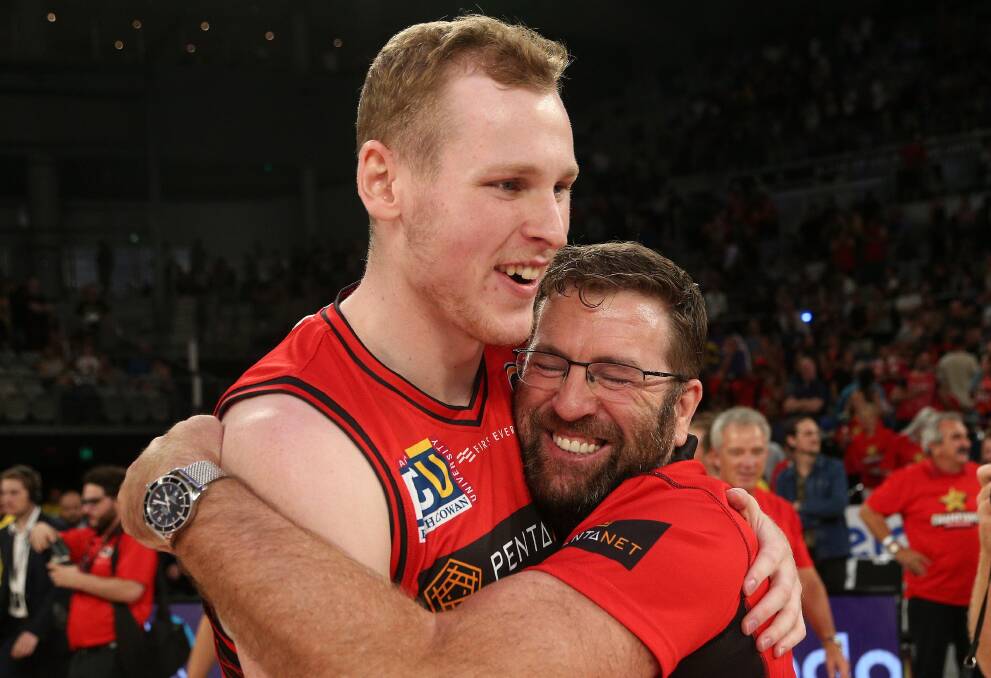 NOT LEAVING: Rhys Vague of Perth (left) celebrates with coach Trevor Gleeson after they claimed the 2019 NBL championship on Sunday. Picture: AAP Image/Hamish Blair