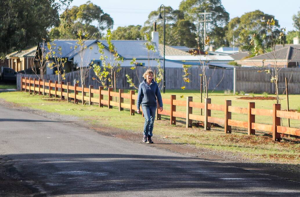 NEW: Port Fairy to Warrnambool Rail Trail volunteer Julia Schlapp checks out the upgraded fence.
