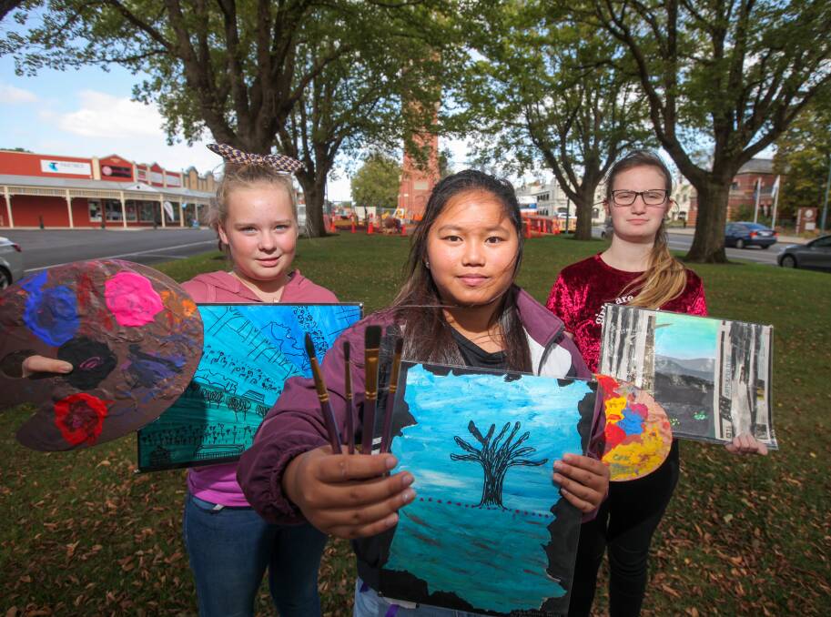 Creative: Camperdown College students Eagan Winsall, 13, Seliva Suson, 12, and Tenesha Anson, 13, with their art displayed in the Corangamite Shire office.