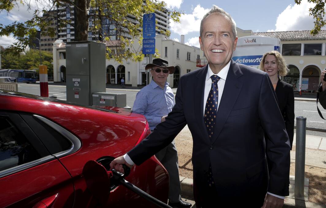 Opposition leader Bill Shorten poses with an electric car during the launch of Labor's Climate Change Action Plan in Canberra on Monday. Photo: Alex Ellinghausen