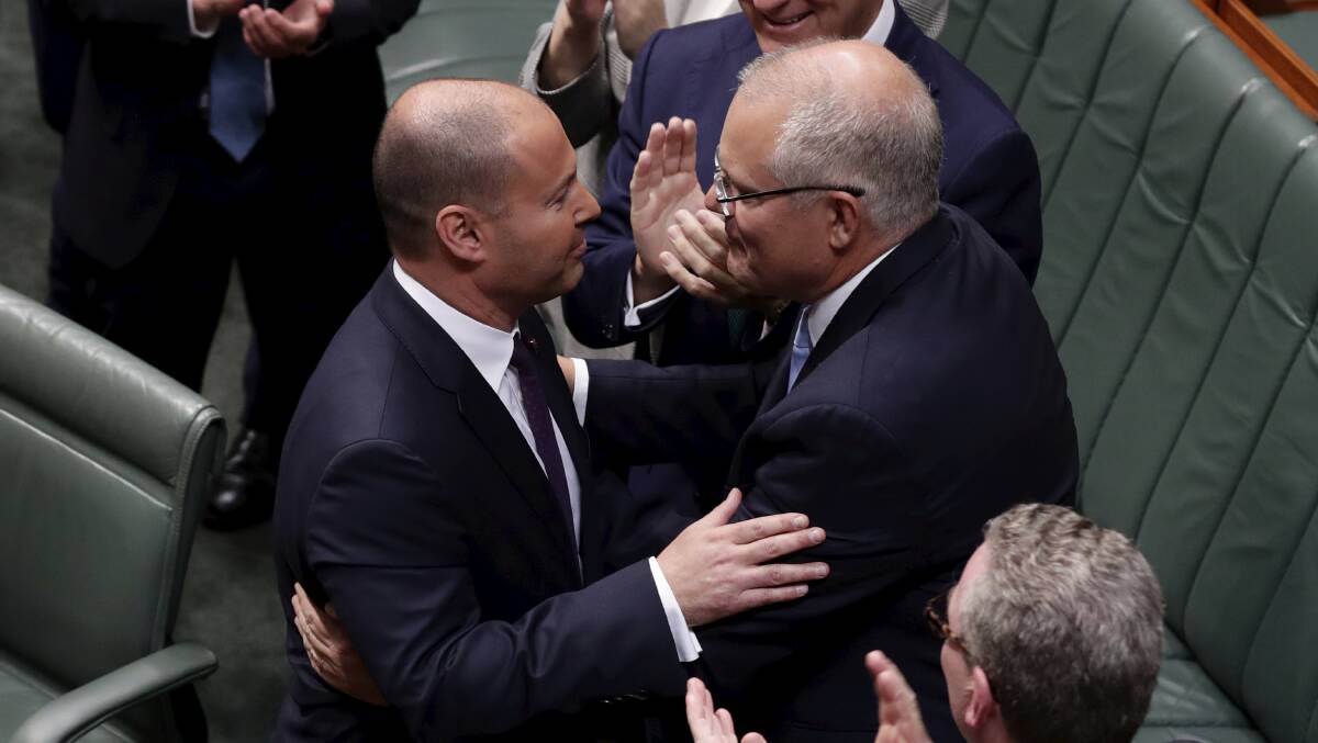 Treasurer Josh Frydenberg is congratulated by Prime Minister Scott Morrison after delivering the Budget speech in the House of Representatives at Parliament House in Canberra on Tuesday night. Photo: Alex Ellinghausen