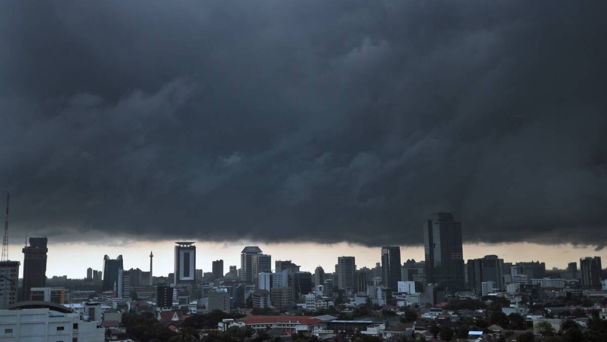 Ominous storm clouds hover over the main business district prior to a downpour in Jakarta, Indonesia.