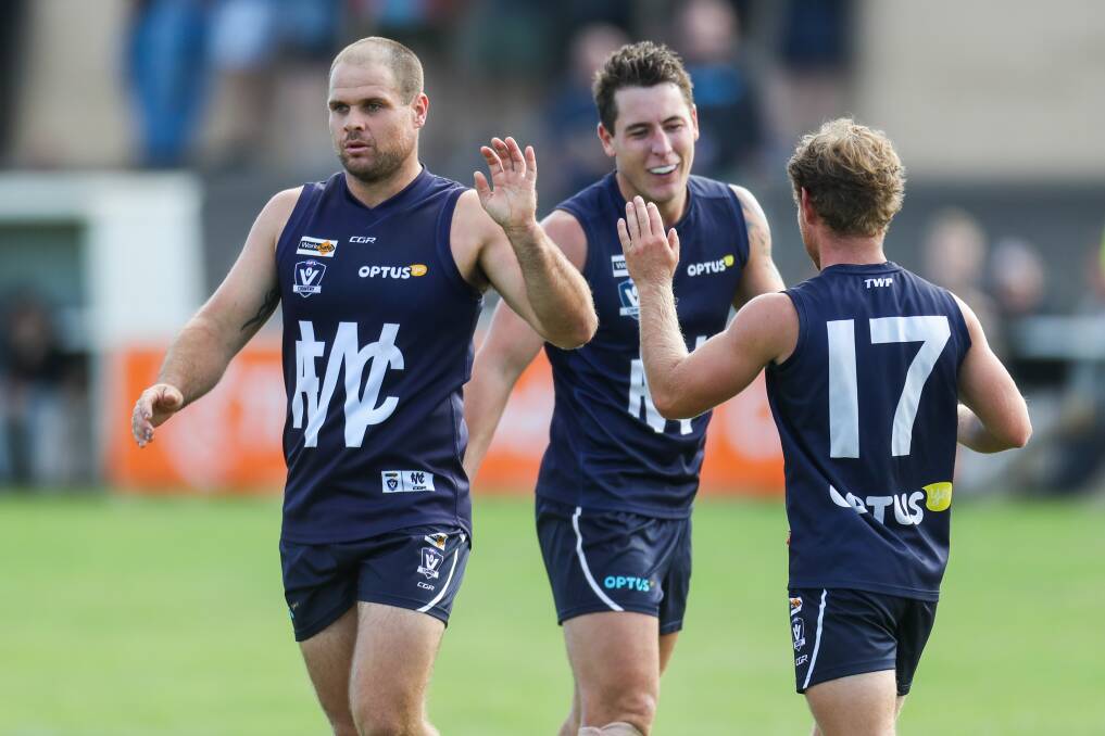 BIG HAUL: Warrnambool's Darren Ewing (left) celebrates kicking one of his 11 goals with teammates Sam Cowling and Jye Turland on Saturday. Picture: Morgan Hancock 