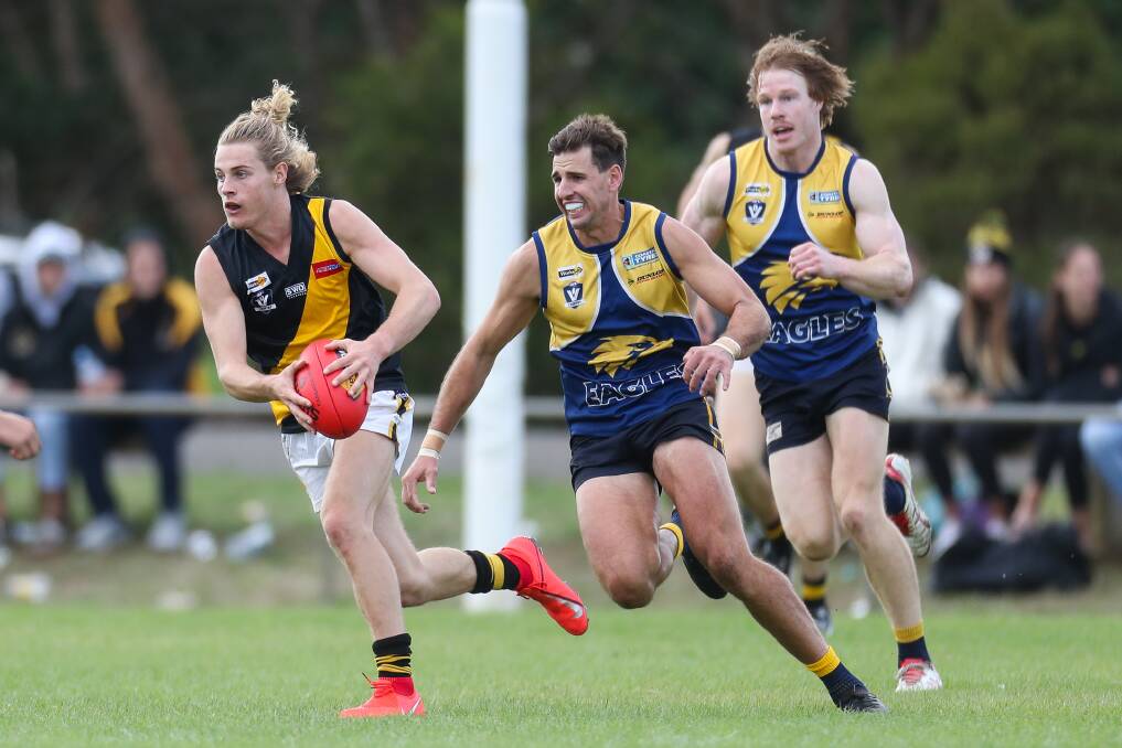 RUN AND CARRY: Portland's Zane Barker bursts away from North Warrnambool Eagles' Tom Batten and Adam Wines on Saturday. Picture: Morgan Hancock