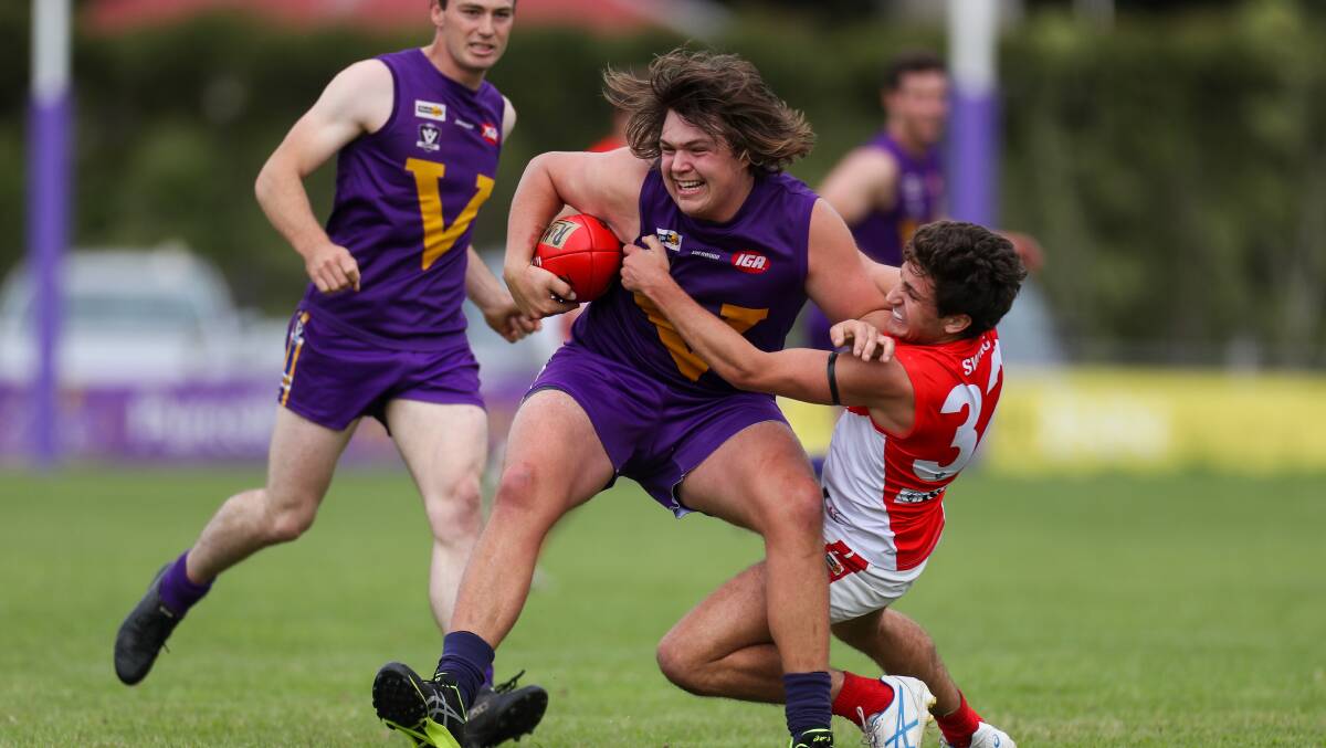 STRONG: Port Fairy's Jake Bartlett takes on South Warrnambool's Paddy Anderson. Picture: Morgan Hancock