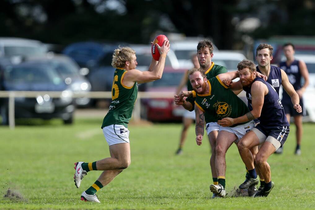Make way: Old Collegians' Michael Lambevski evades the oncoming traffic. Picture: Anthony Brady