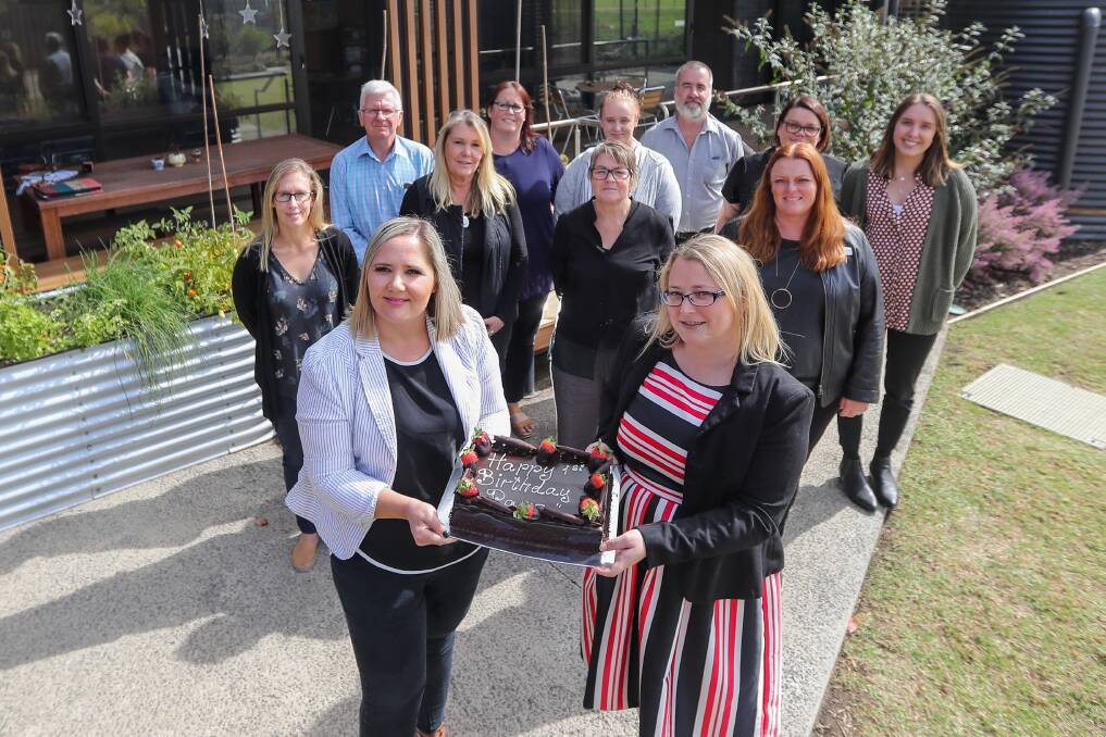 Milestone: Ngootyoong Warrnambool Prevention And Recovery Centre manager Emily Williams and Mind Australia Service Lead Carla Glenister with representatives from Mind Australia and South West Healthcare at the centre's first birthday. Picture: Morgan Hancock
