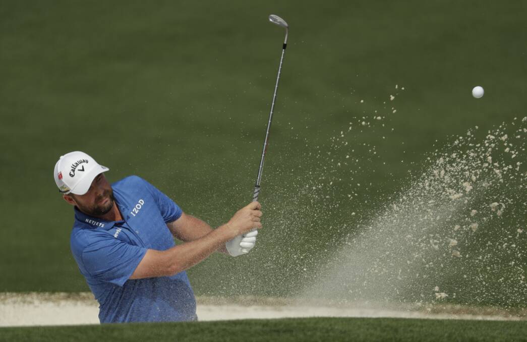 FIGHTING: Marc Leishman hits from a bunker on the second hole during the first round of The Masters on Friday (AEST) in Augusta. Picture: AP Photo/Chris Carlson
