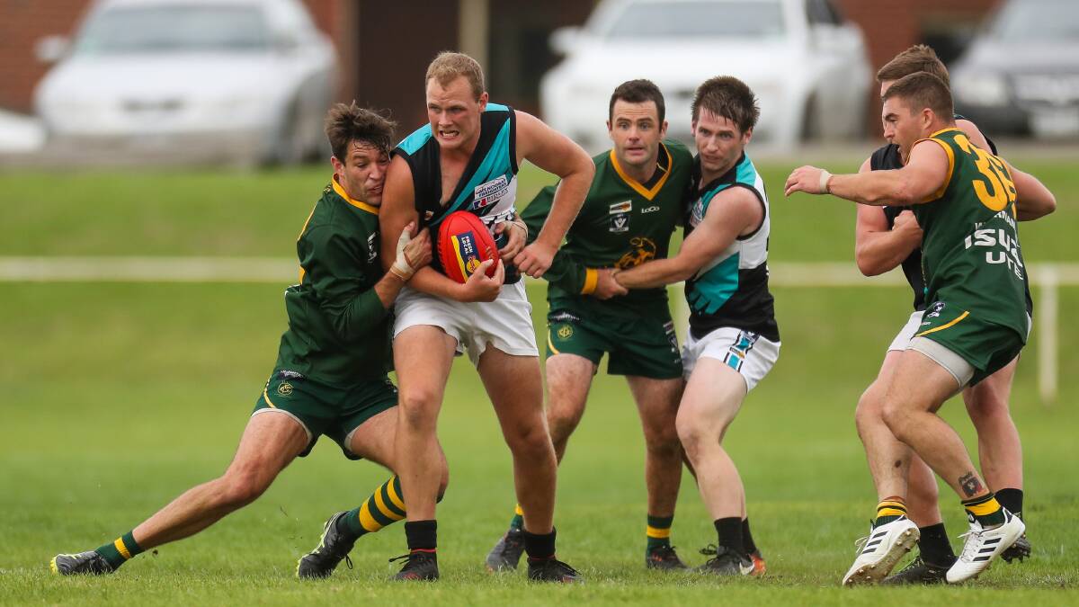 Promising youngster: Kolora-Noorat's Brad Lucas is tackled by Old Collegians' Scott Lenehan. Coach Ben Walsh rates Lucas as his most improved. Picture: Morgan Hancock