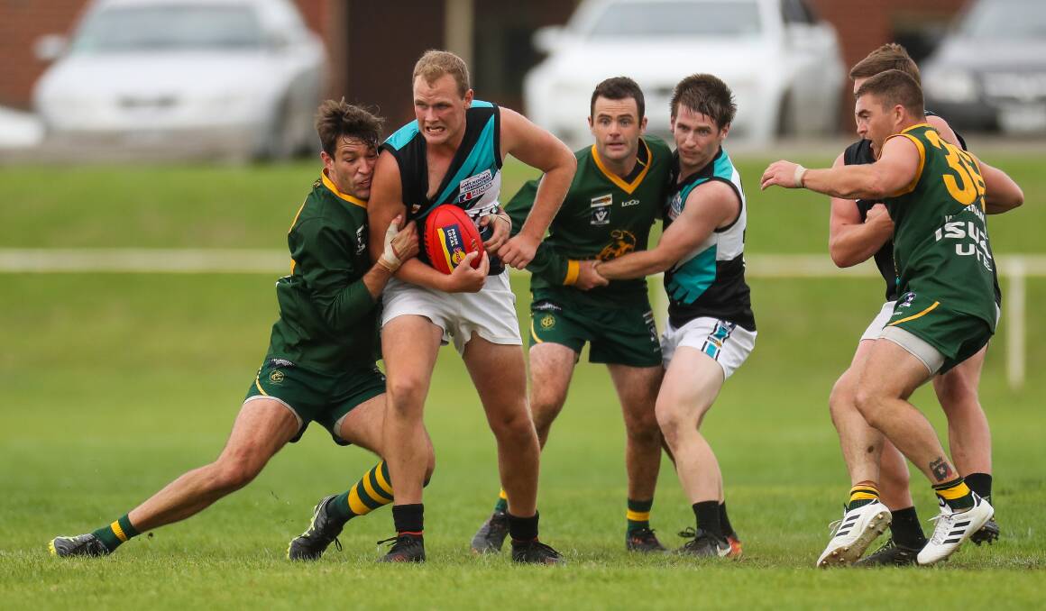 OUTTA MY WAY: Kolora-Noorat's Brad Lucas is tackled by Old Collegians' Scott Lenehan earlier this season. Lucas is relishing the chance to play senior football. Picture: Morgan Hancock
