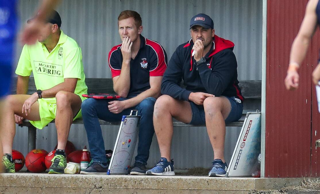 TACTICAL THOUGHTS: Jordie McKenzie and Michael Sargeant look on from the bench at Terang Mortlake. Picture: Morgan Hancock