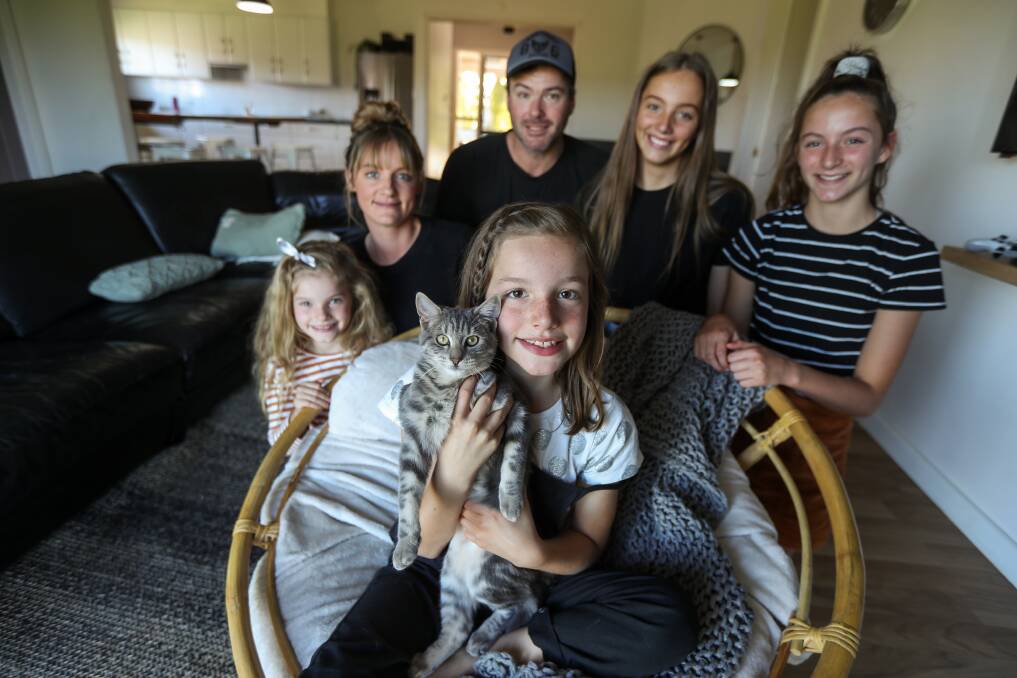 BRAVE BATTLE: Lottie Wallace, with cat Dimi, is surrounded by sister Tilly, 6, mum Alisha, dad Allan and sisters Montana, 14, and Bella, 13, at their Nullawarre home. Picture: Rob Gunstone