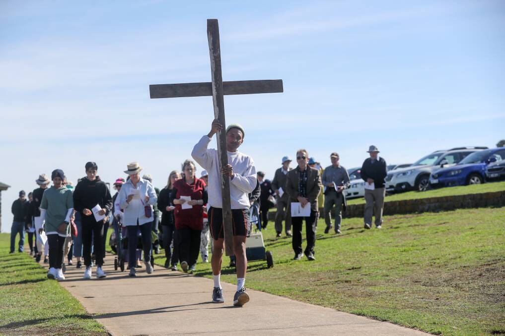 RECLAIMING THE SACRED: Uniting Church member Mathi Subramaniyan holds the cross for the Combined Churches Walk of Witness at Cannon Hill on Good Friday. Picture: Rob Gunstone