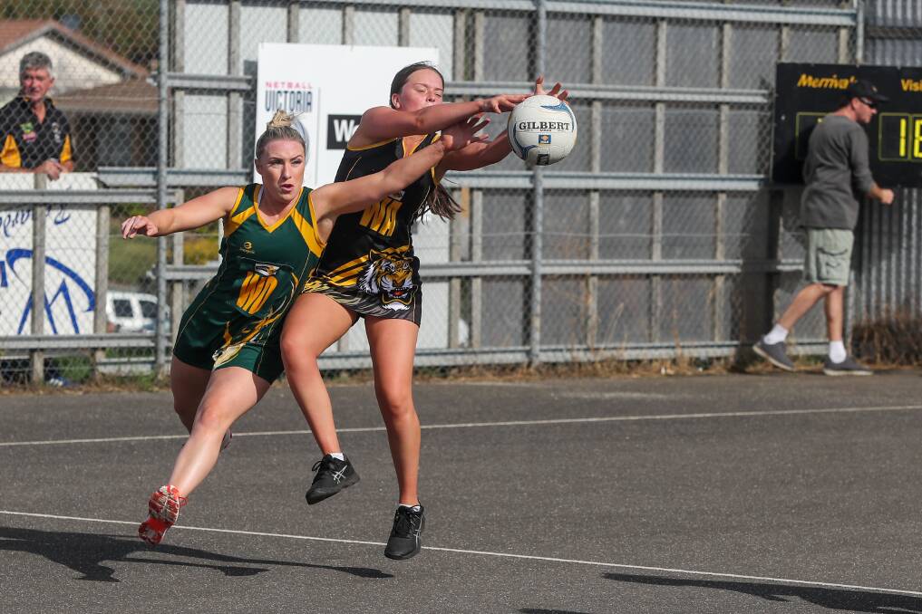 Tough battle: Old Collegians wing defence and co-coach Meagan Forth tries to stop Merrivale wing attack Eliza Ljubic from receiving the ball. The Warriors survived a fourth-quarter scare to win by two goals on Good Friday. Picture: Rob Gunstone