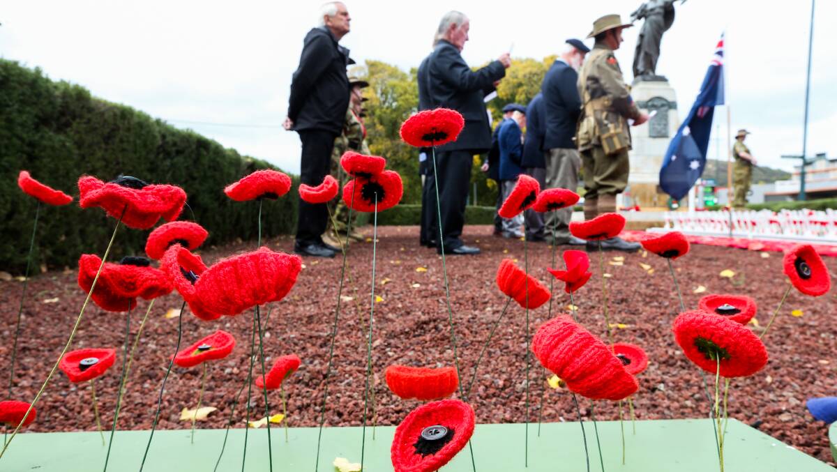 Honoured: Returned servicemen stand on parade in front of handmade poppies at the Camperdown Anzac Day service. Picture: Rob Gunstone