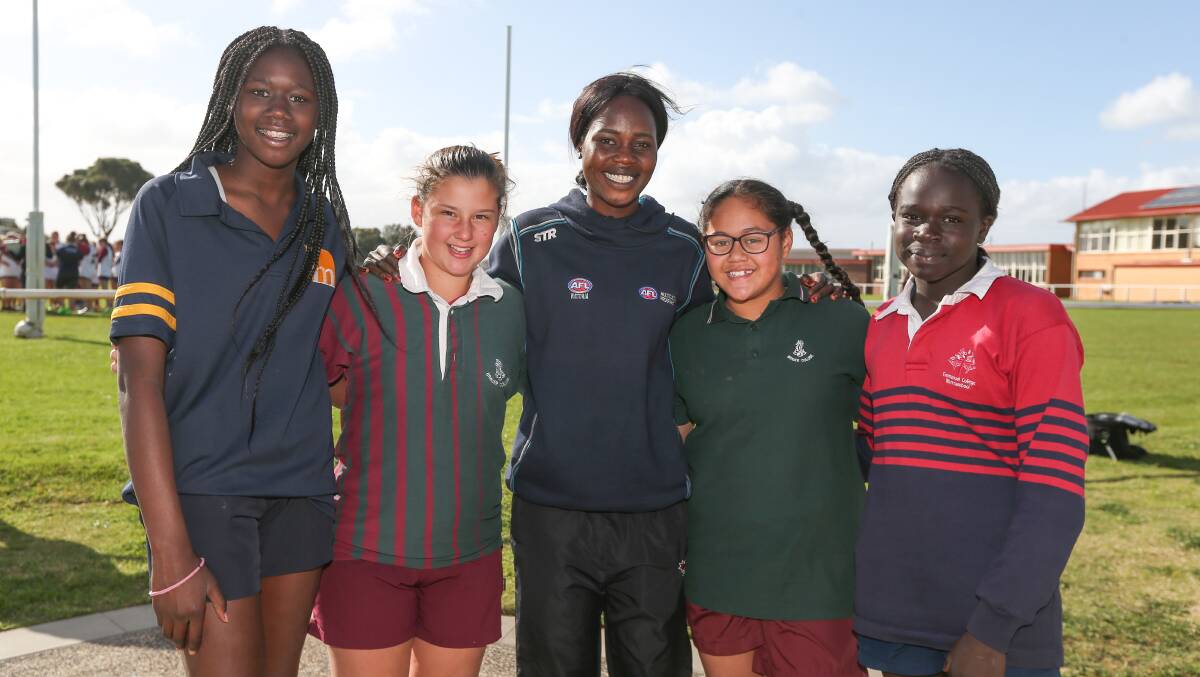 STAR VISIT: AFL Victoria Multicultural Development Officer and Richmond AFLW player Akec Makur Chuot (centre) with footballers Nam Nabong, 13, Carisma Corpaci, 13, Ihipera Sciascia, 13, and Ywomo Ajang, 13. Picture: Rob Gunstone