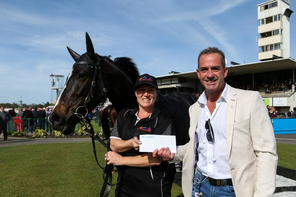 GREAT: Strapper Kylie Scott, with Wicked Trilogy trained by Brett Scott, receives her prize from Behind The Barriers organiser Jason Petch. Picture: Rob Gunstone