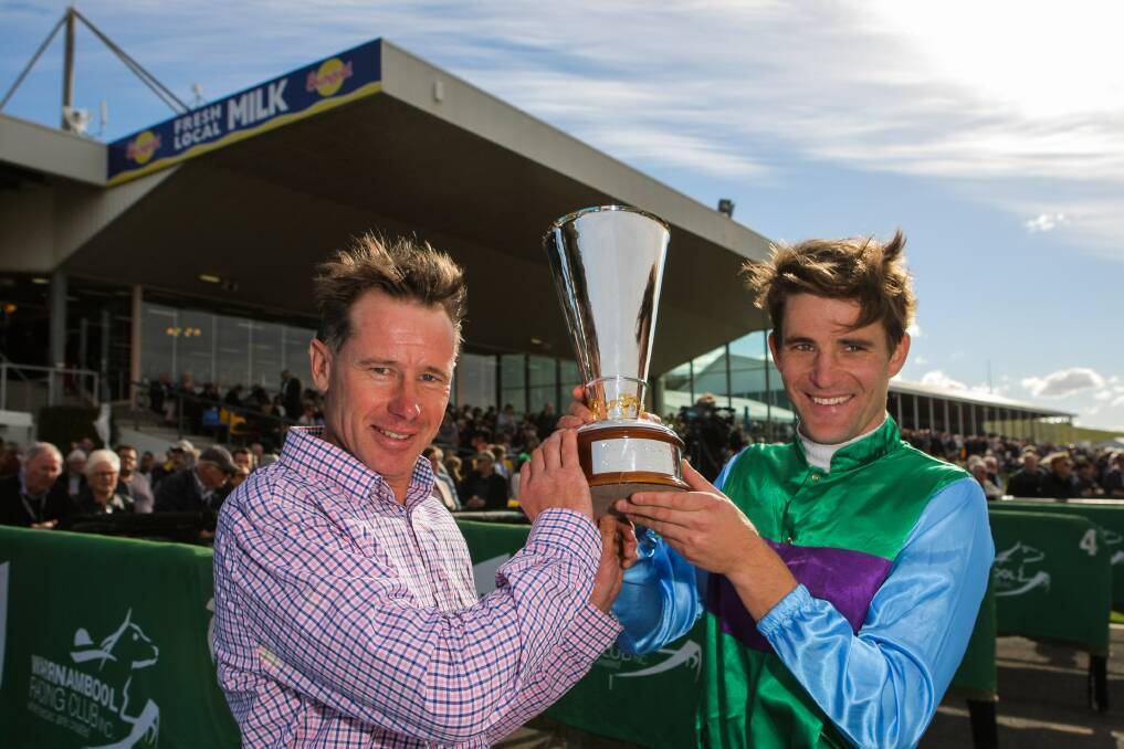 You ripper: Trainer Patrick Payne and jockey Steven Pateman with the Grand Annual trophy after Zed Em's triumph. Picture: Rob Gunstone