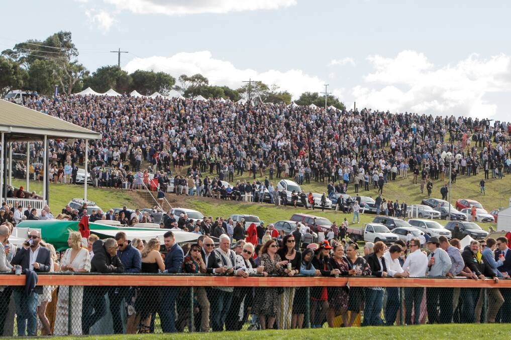 A massive crowd fills the hill at Warrnambool Racecourse to watch the Grand Annual in 2019. Picture: Rob Gunstone