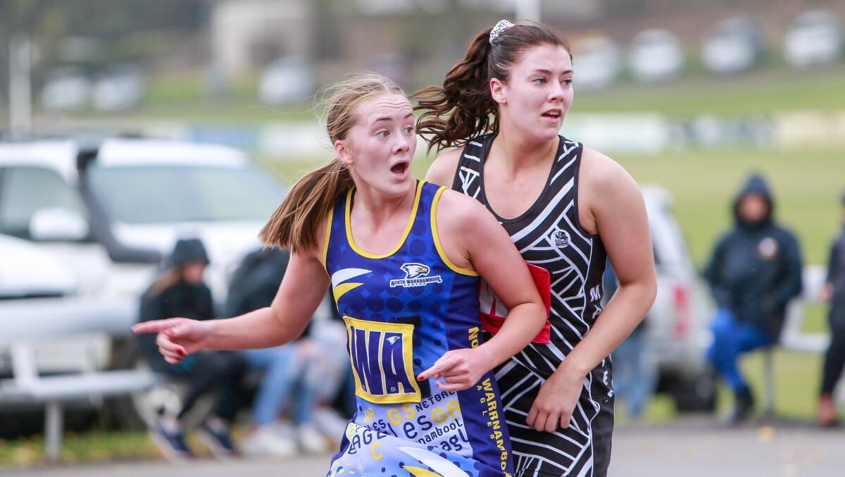 INTO POSITION: North Warrnambool Eagles' Amelia Chow and Camperdown's Caitlin Hall jostle for the front spot and first touch of the netball. Picture: Anthony Brady