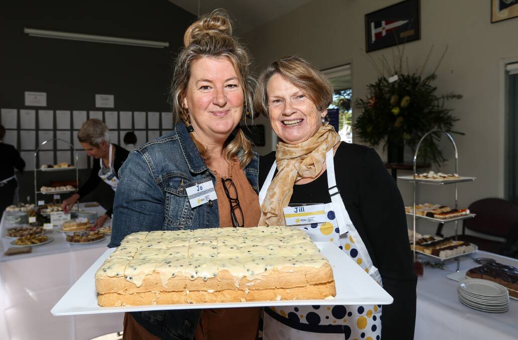 TASTY: Jo O'Keefe and Jill Gleeson show off some delicious cake as they prepare for the morning tea. Picture: Christine Ansorge
