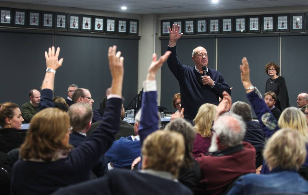 Hands up for action: Kolora farmer Peter Allen calls for a show of hands to support a moratorium on the windfarm development during the information session. Picture: Rob Gunstone