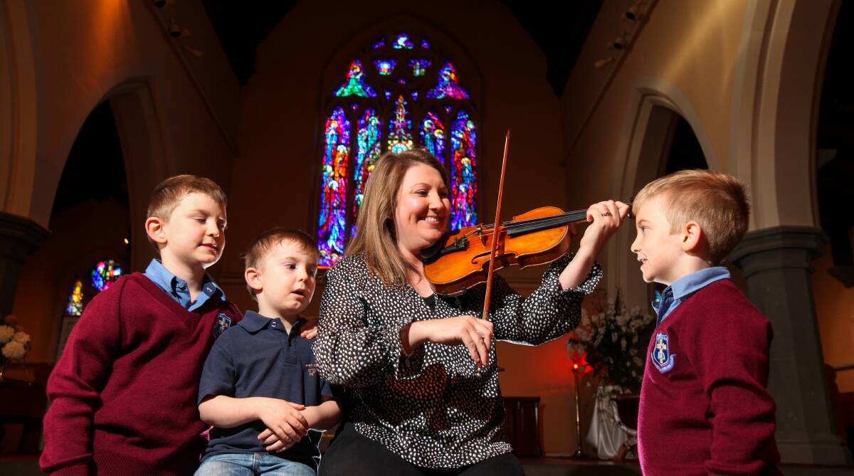 Harmonious: WSO 1st violin Katie Ezzy will be performing in the Mother's Day concert, pictured with her children Henry, 7, George, 4, and Albie, 6.