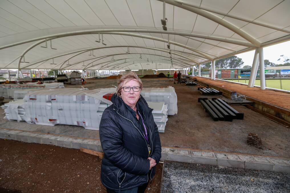 UNDERCOVER: City Memorial Bowls Club general manager Julie Dosser checks out a newly finished roof that will cover two of the club's greens. Picture: Anthony Brady