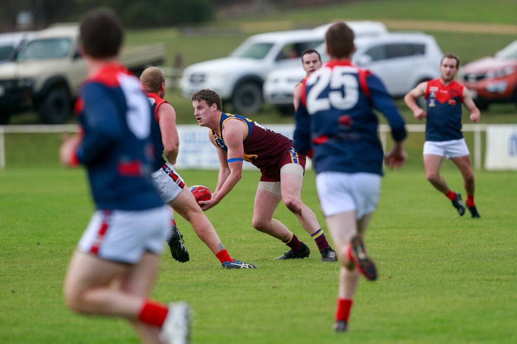 In tight: Alex White, one of South Rovers' best against the Timboon Demons, handballs in traffic. Picture: Anthony Brady