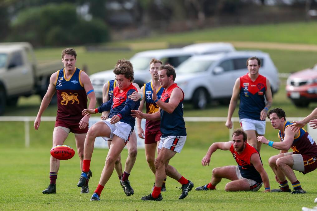 Young gun: Timboon Demons player Jordy Fowler gets a kick out of congestion. Picture: Anthony Brady