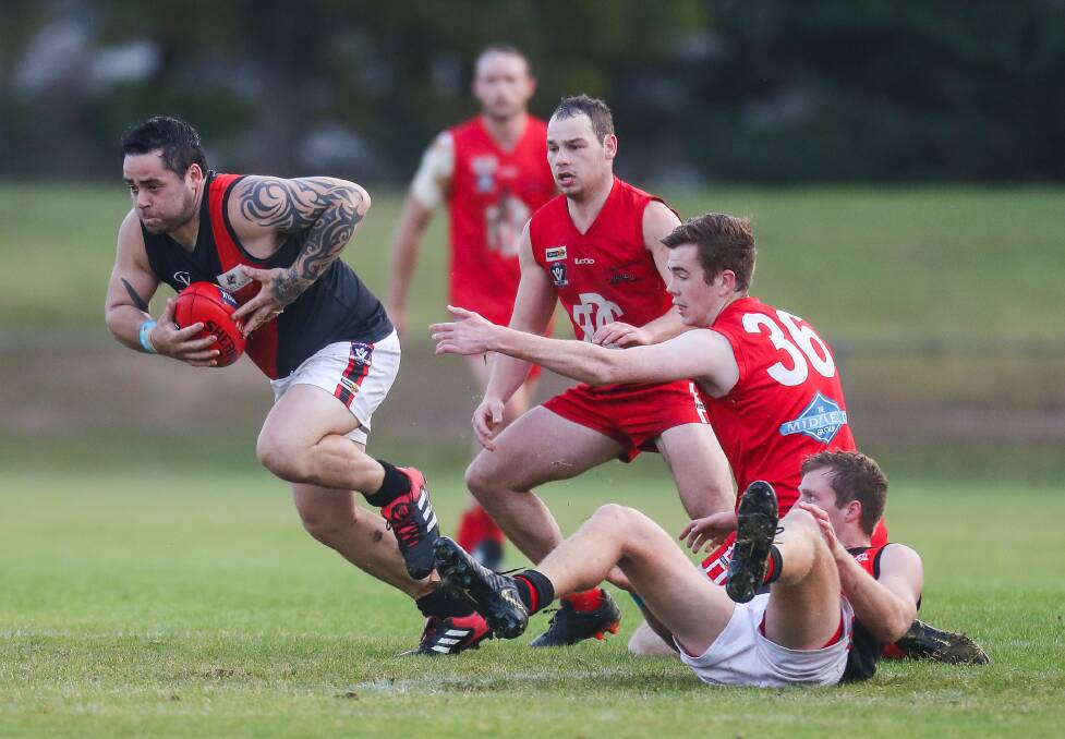 Too good: East Warrnambool's Corey Brown avoids the clutches of Dennington's Mitch Fogarty and gathers a clearance. Picture: Morgan Hancock