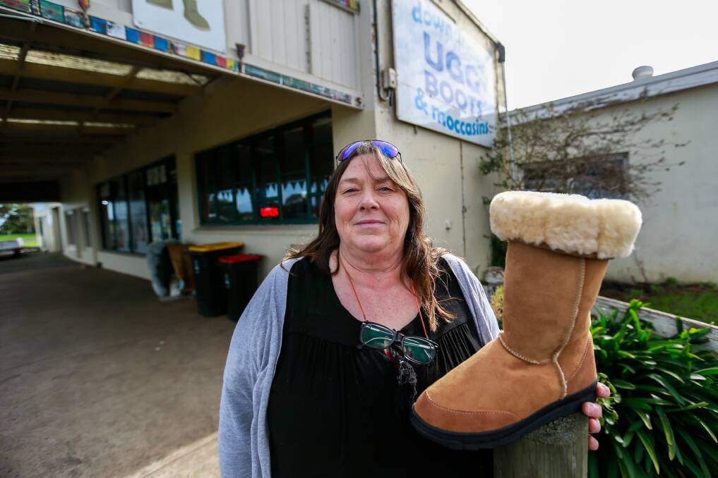 REAL: Killarney's Ugg Down Under employee Heather Stewart with some of the store's wares. Confusion about about the product means the store is regularly asked if the boots are real. Picture: Anthony Brady