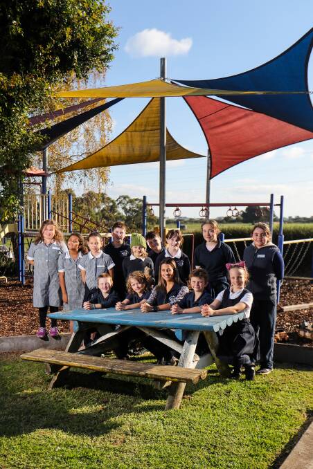 All class: Veronica 'Ronnie' Couch, pictured here with the entire school of 13 students, has returned to teach at Panmure Primary School after attending the school as a student. Picture: Morgan Hancock