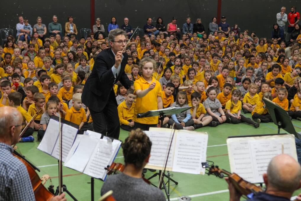 Final performance: Warrnambool Primary School student Evie Hollonds, 7, steps up to assist Warrnambool Symphony Orchestra conductor Angus Christie. Picture: Rob Gunstone