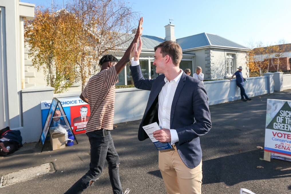Engaging youth: Alex Dyson high fives a young voter. Picture: Morgan Hancock