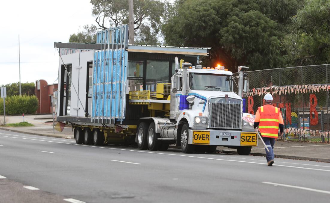 ARRIVAL: Trucks brought a new classroom to the Warrnambool Primary School from Geelong. Picture: Morgan Hancock