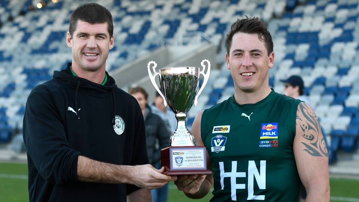 BOTTLE GREENS: Jonathan Brown and Sam Cowling show off the spoils of a victory over Ballarat Football Netball League in May. Picture: Adam Trafford/Ballarat Courier