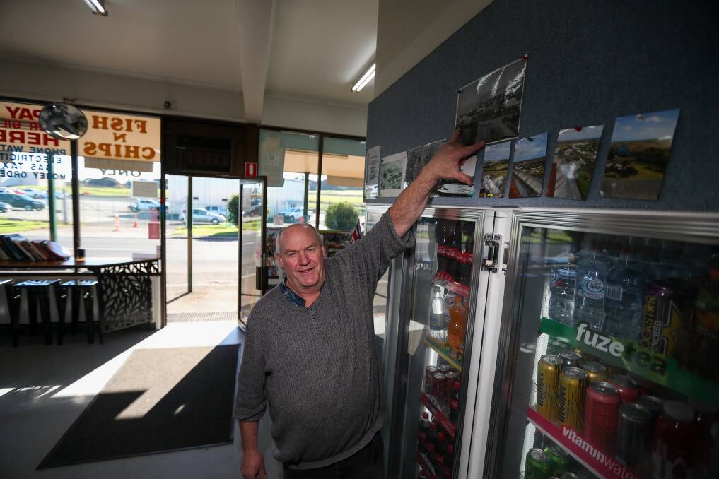 History lost: Tom Bertrand points to a photo of the Dennington General Store, which was standing before the Dennington Fonterra factory was built. Fonterra announced that it will shut down it's Dennington base in November. Picture: Morgan Hancock