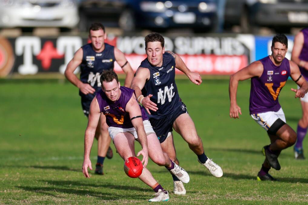 Standout: Port Fairy's Colin Harwood, who was best on during his side's 29-point loss to Warrnambool, scoops up the ball in the midfield. Picture: Anthony Brady