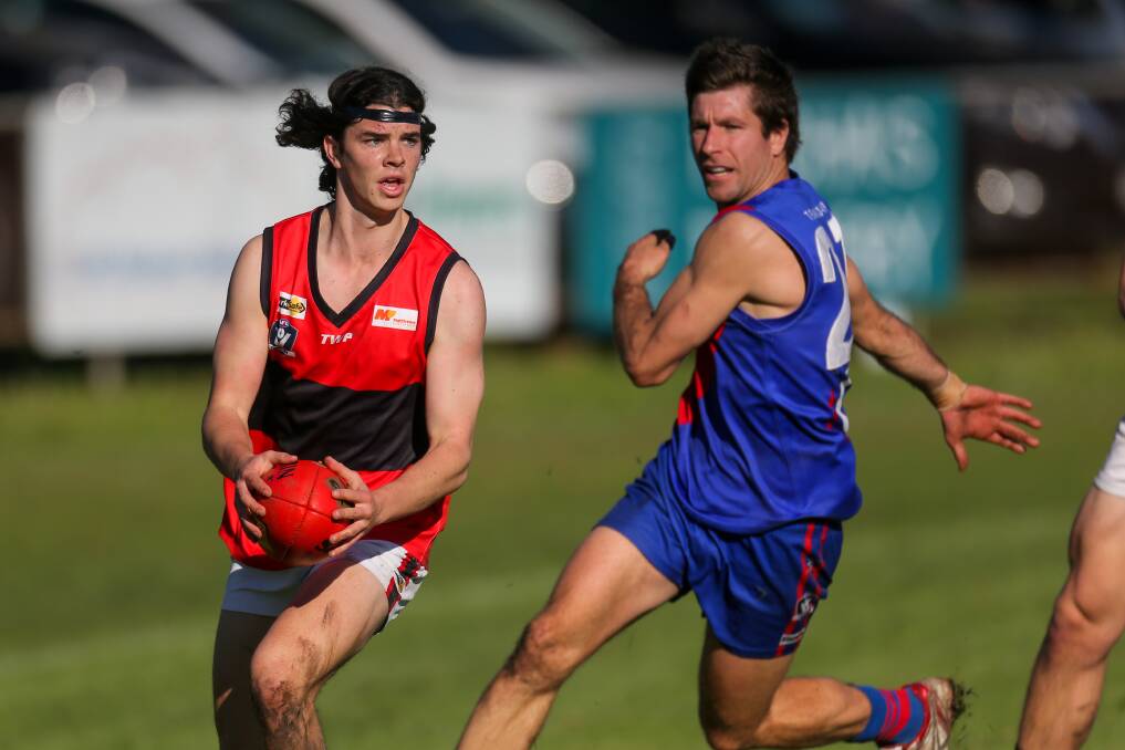 WELCOME BACK: Cobden's Patrick Smith, pictured opposed to Terang Mortlake's Chris Baxter, played his first game of the season on Saturday. Picture: Rob Gunstone