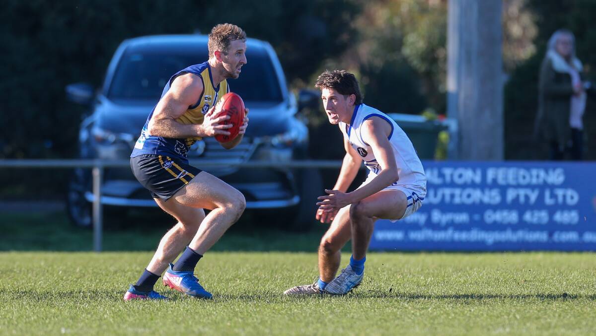 GUESS WHO'S BACK?: North Warrnambool Eagles' Michael Barlow slips around Hamilton Kangaroos' Jack English earlier this season. Barlow will take on the Kangaroos for a second time on Saturday. Picture: Rob Gunstone